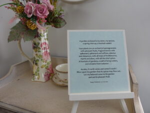 A contemplative table display featuring a framed scripture from Song of Solomon 4:12–16, evoking themes of sacred intimacy, fragrance, and spiritual invitation.